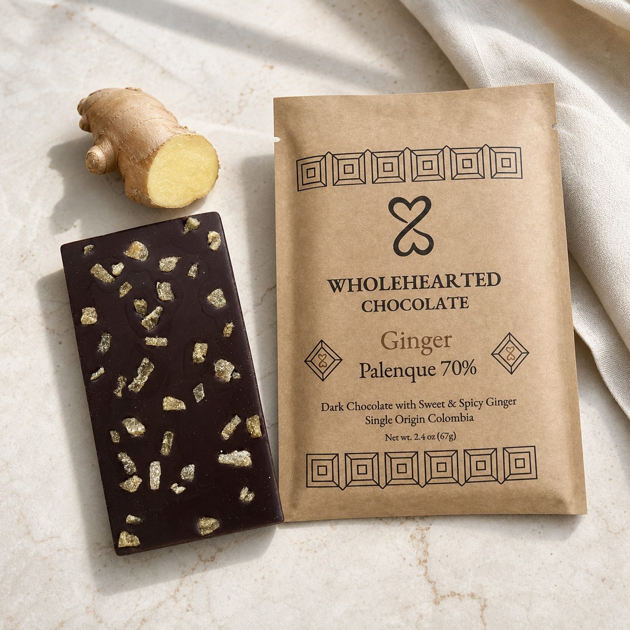Ginger Palenque 70% dark chocolate bar and package beside fresh ginger root