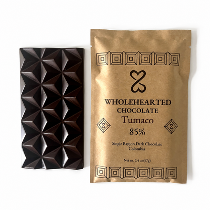 Tumaco 85% molded dark chocolate bar beside its kraft paper package