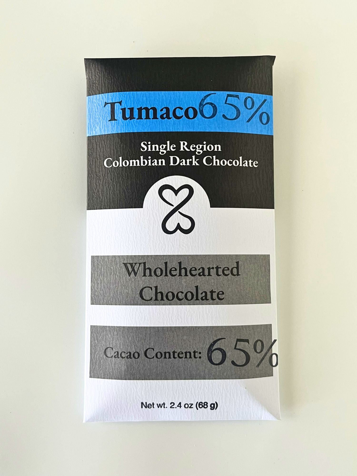 Wholehearted Chocolate bar packaging with Tumaco 65% label on a white background