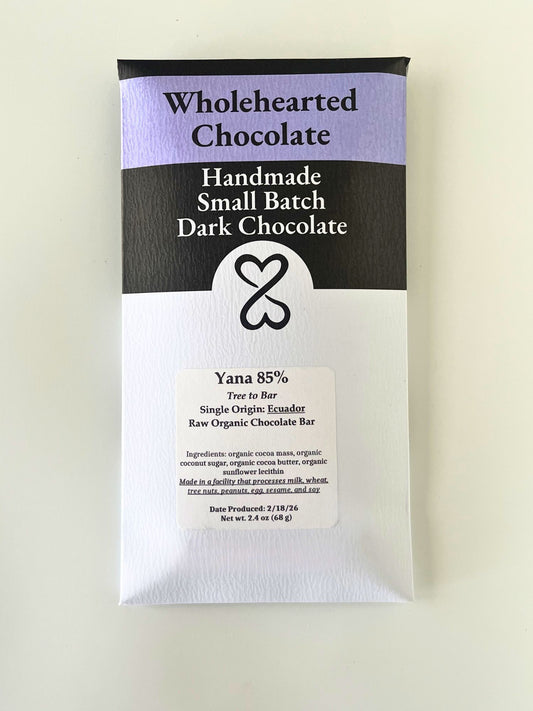 Wholehearted Chocolate bar packaging on a light beige background. ecuador 85% dark chocolate bar