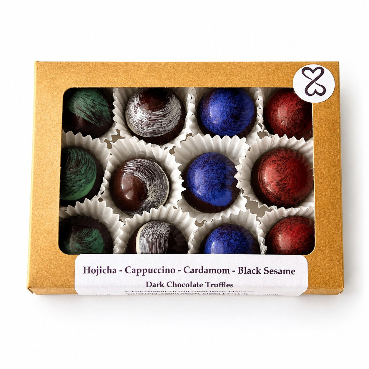 Box of dark chocolate truffles with colorful coatings on a white background