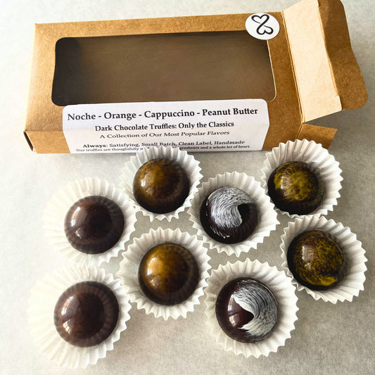 Dark chocolate truffles in white paper cups with a kraft paper box labeled "only the classics"