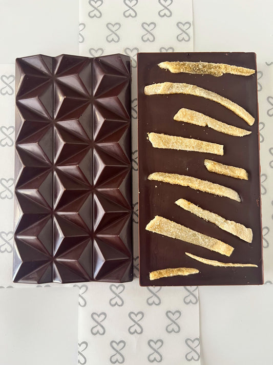 front and back of dark chocolate bar topped with crystallized ginger